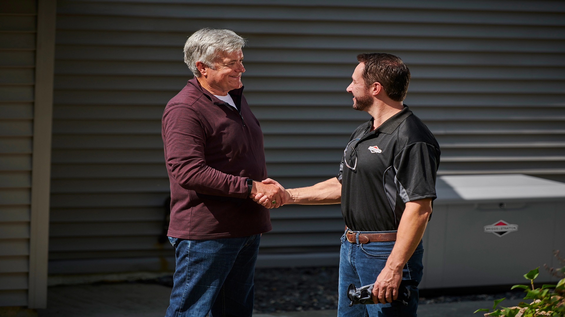 a man shaking hands with another man