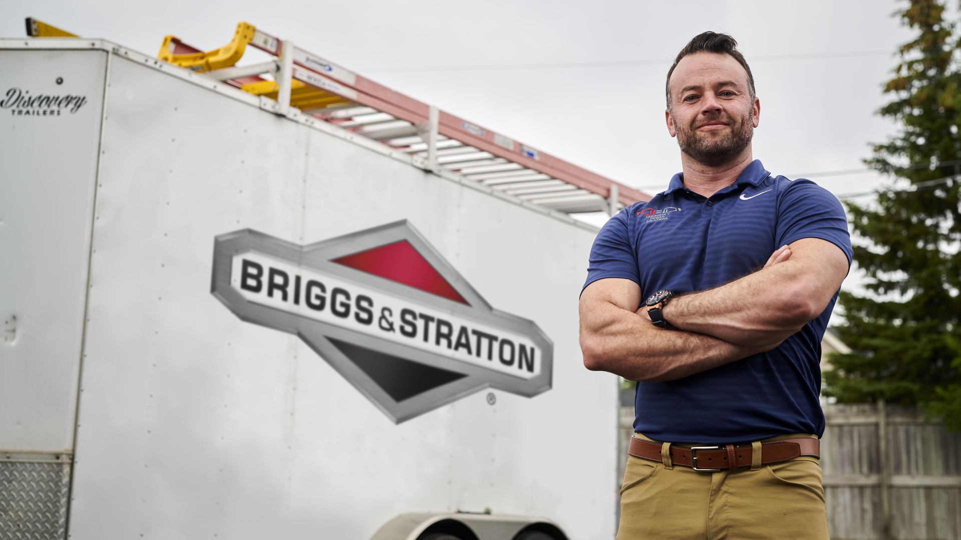 a man standing next to a sign