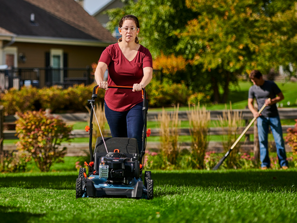 Woman pushing a Briggs & Stratton lawn mower