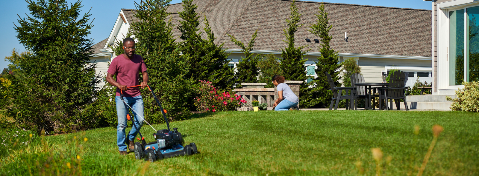 Woman performing maintenance on  a Briggs & Stratton powered lawn mower