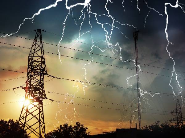 Power lines with sun and lightning
