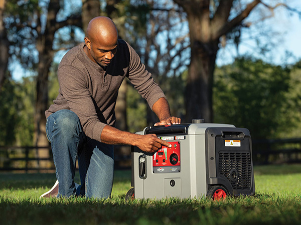 Man operating portable generator.