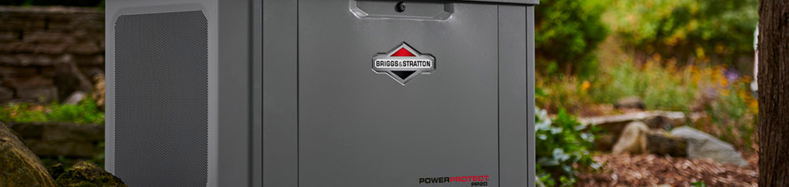 Standby generator in landscaping near a house.