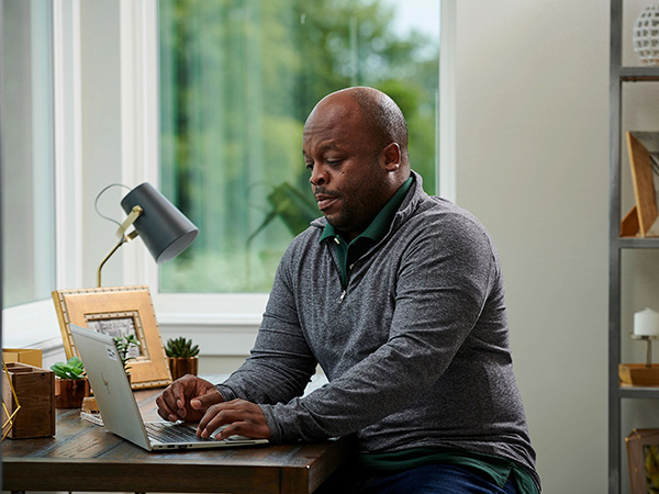 Man Researching on Laptop