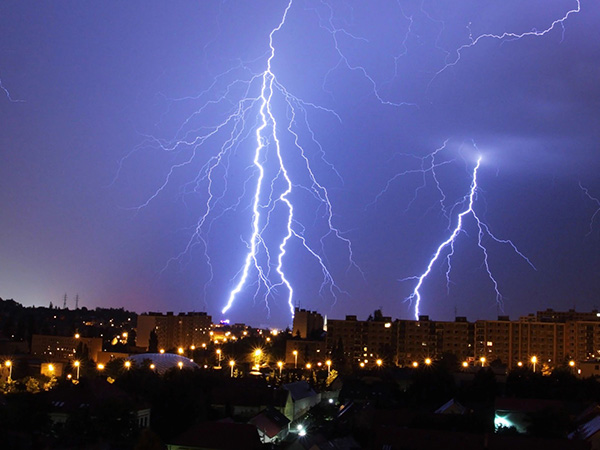 Storm with lightning over city