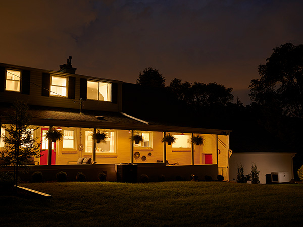 Generator outside lit home