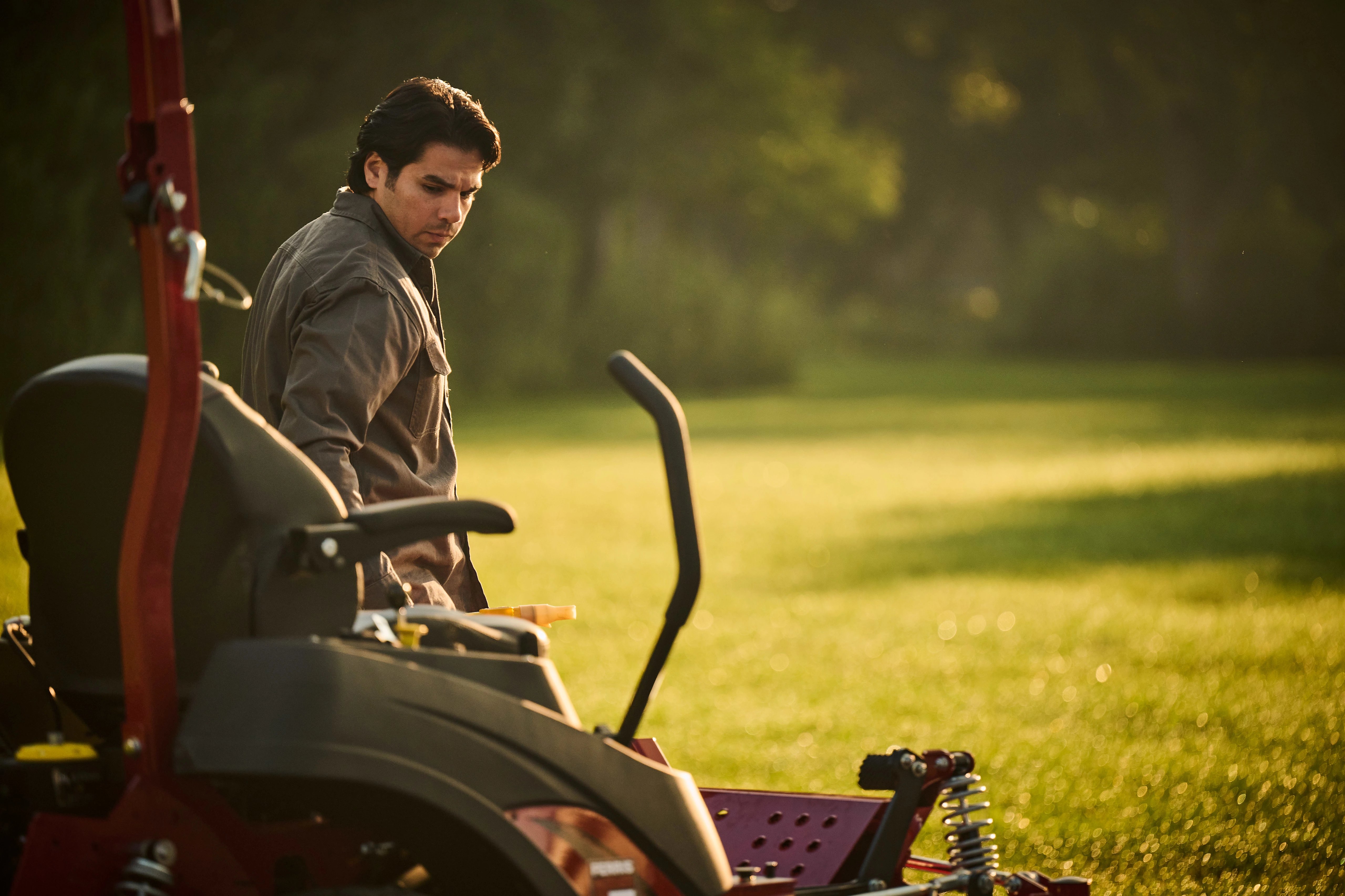Man next to a Ferris ZTR powered by a Briggs & Stratton CXi with Oil Xtend.