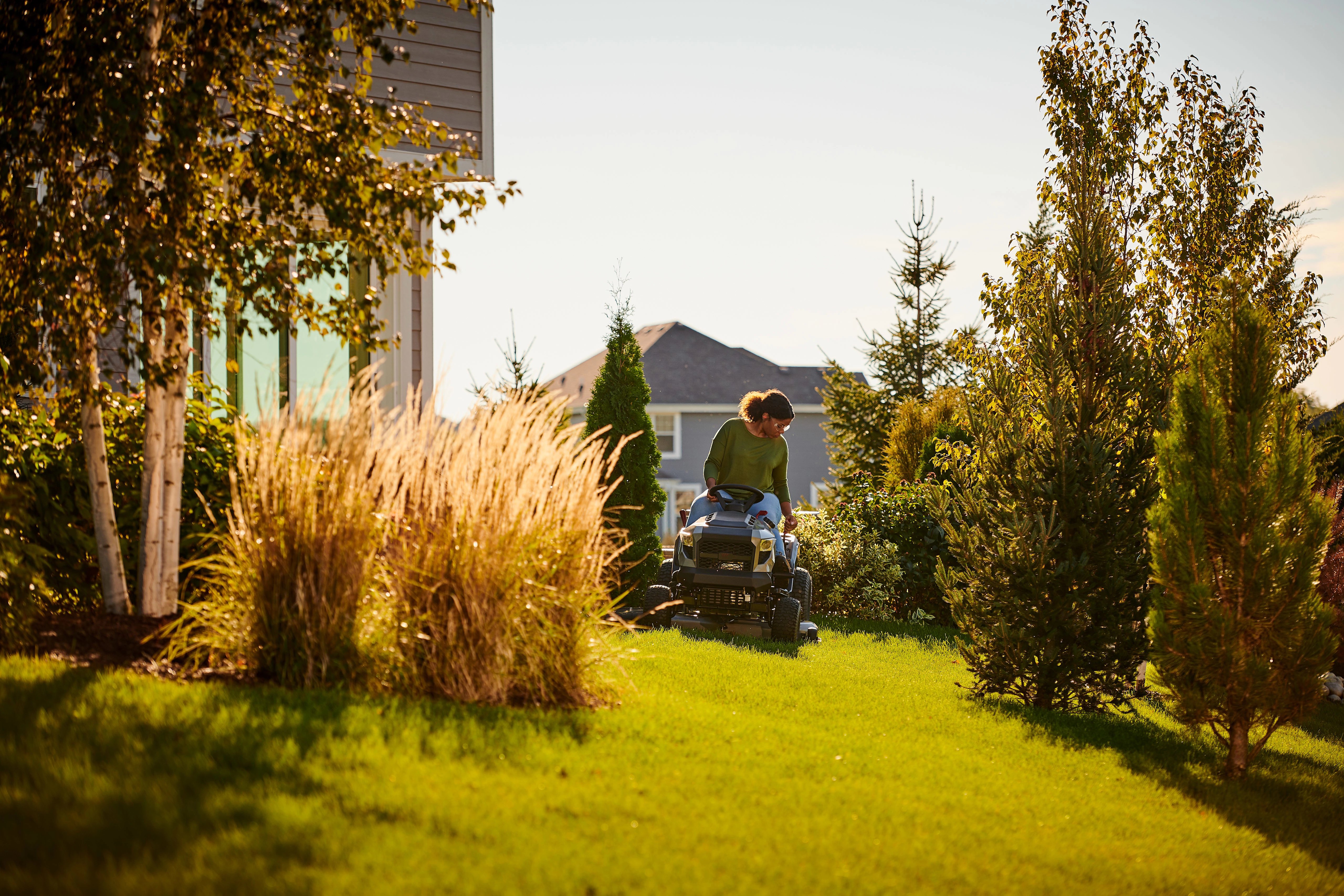 Woman sitting comfortably on a Murray riding mower.